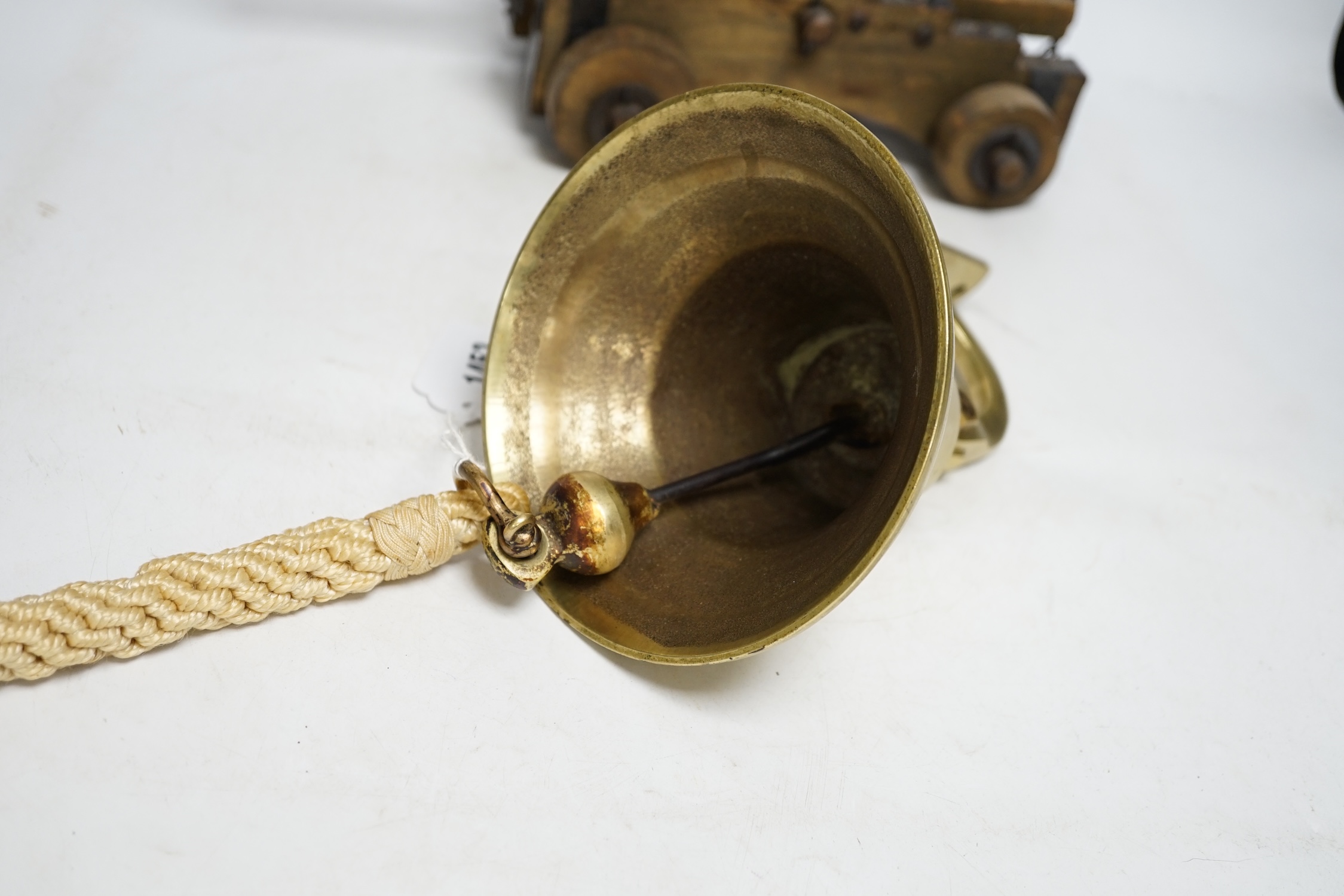 A brass ship's bell and a model cannon, largest 36cm wide. Condition - fair